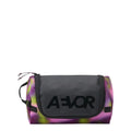 Lieblingstasche Aevor Wash Pack toiletry bag in a vibrant purple and green tie-dye pattern with black logo detail