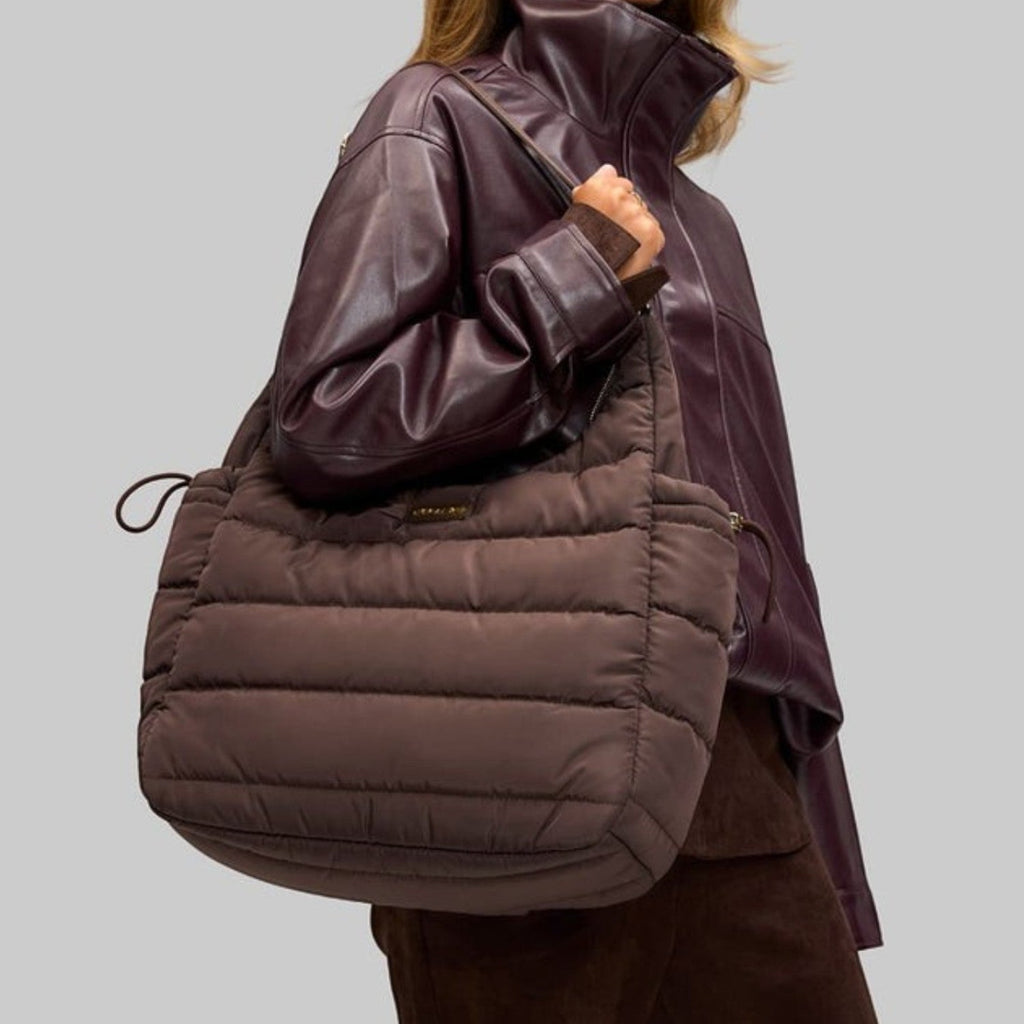 Lieblingstasche Alltime Buddy quilted brown shoulder bag worn by a woman in a dark leather jacket
