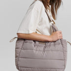 Lieblingstasche Alltime Buddy quilted taupe shoulder bag worn by a woman in a white top