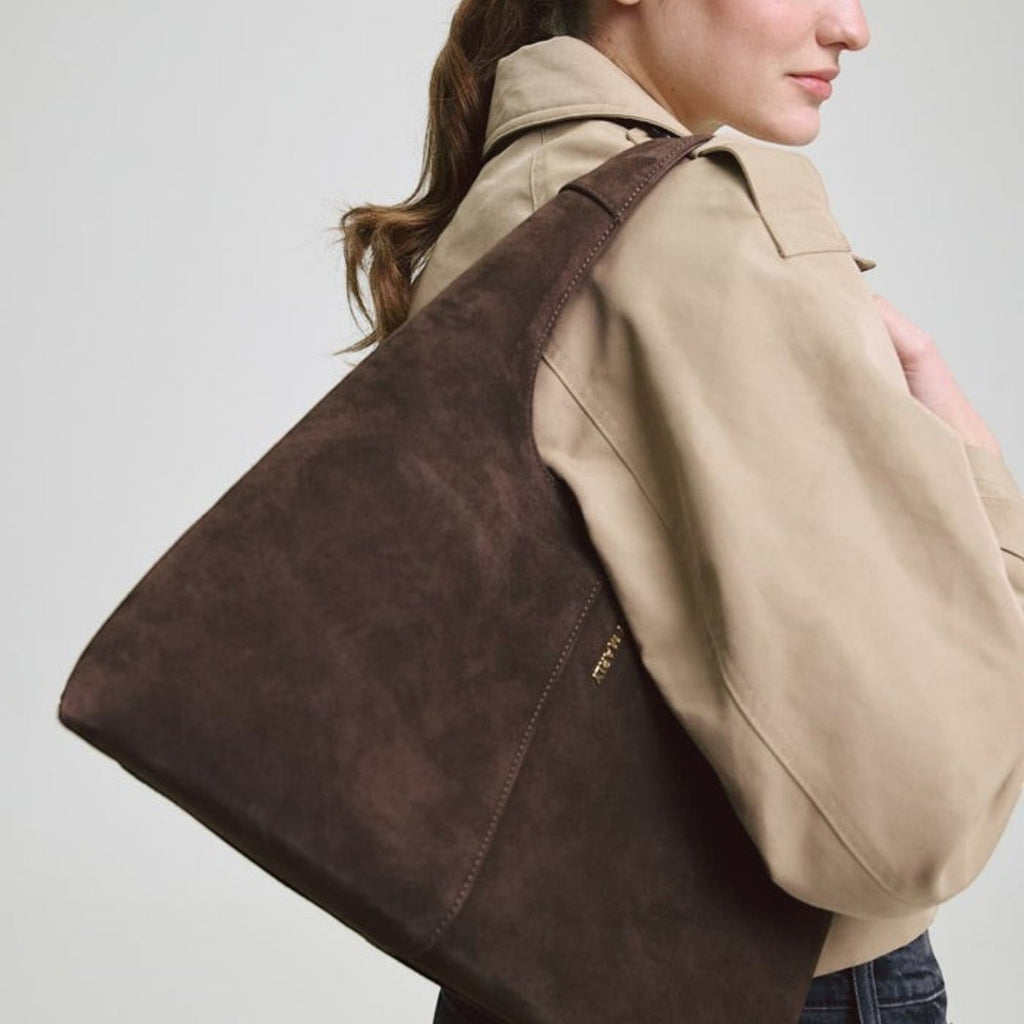 Lieblingstasche Alltime Lover ReSuede M dark brown suede shoulder bag worn by a woman in a beige trench coat