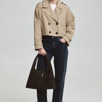 Lieblingstasche Alltime Lover ReSuede M dark brown suede hobo bag held by a model in a beige trench coat