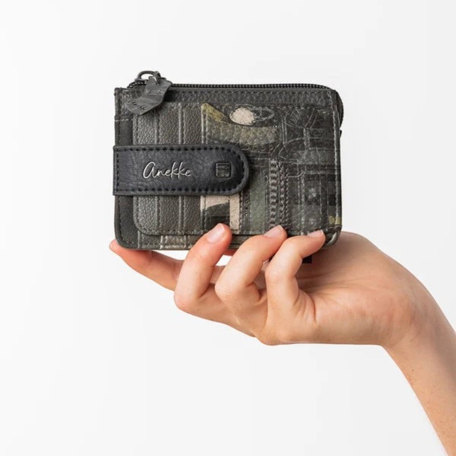 Lieblingstasche Anekke patterned card holder with a black snap closure held in a hand against a white background