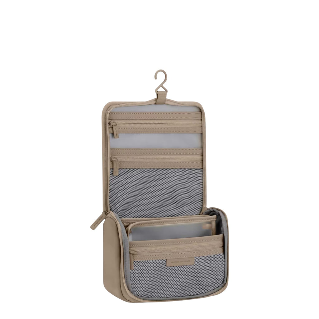 Lieblingstasche Bali washbag in beige with a hanging hook, multiple mesh compartments, and clear zippered pockets.