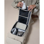 Lieblingstasche Bali Pro beige backpack open showing organized interior with toiletries and tech accessories.