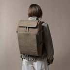 Lieblingstasche Bali Pro taupe faux leather backpack with zip pocket and side pockets, worn by a model.