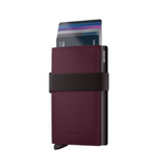Lieblingstasche Bandwallet Matte in dark burgundy with a black elastic strap and card holder mechanism