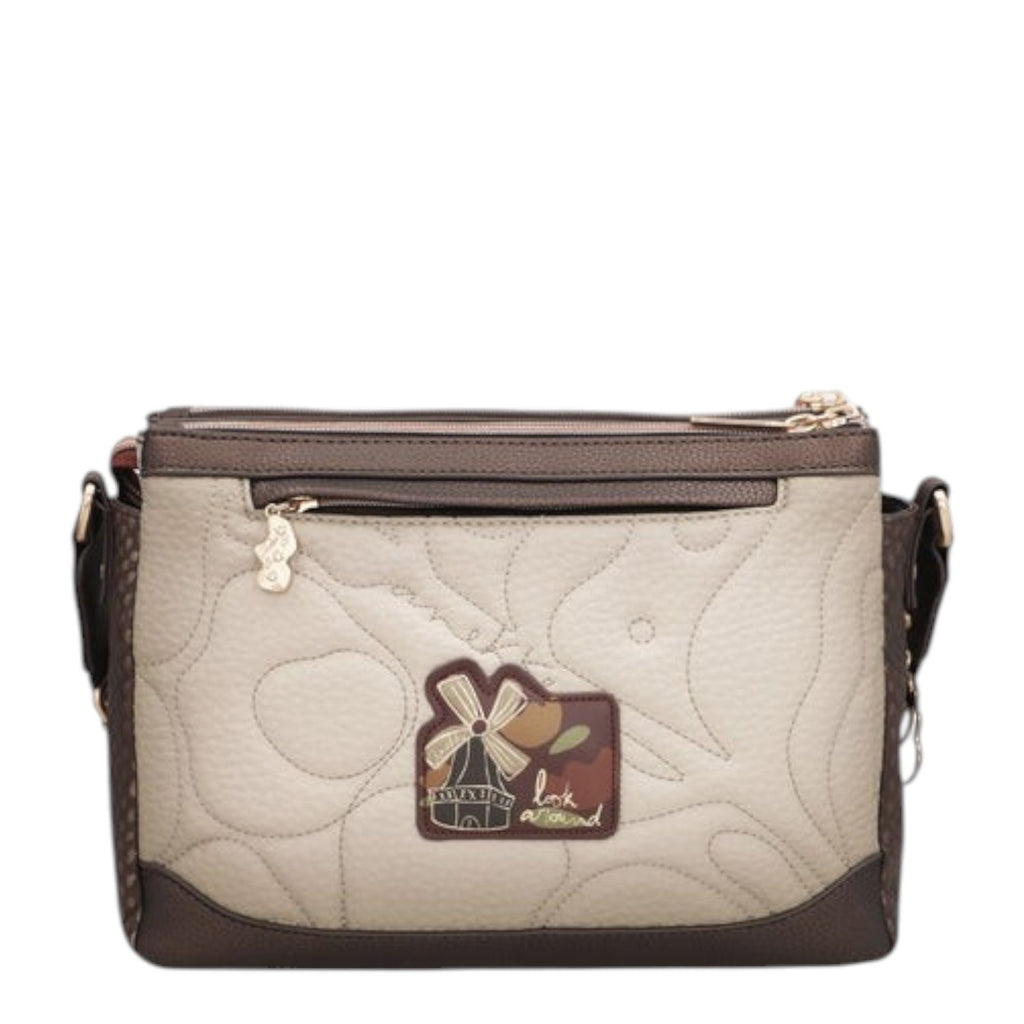 Lieblingstasche beige and brown cross-body bag with quilted texture, windmill patch, and gold zipper hardware