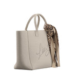 Lieblingstasche Tote L in beige canvas with a decorative leopard print scarf tied to the handle