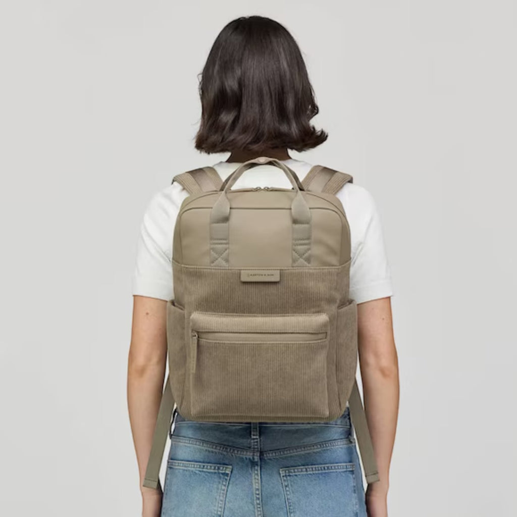 Lieblingstasche Bergen Pro Limited Edition Cord backpack in beige corduroy worn on a woman's back