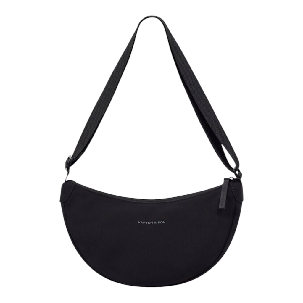 Lieblingstasche Essential Moon Bag in black with a crescent shape, adjustable shoulder strap, and zipper closure.