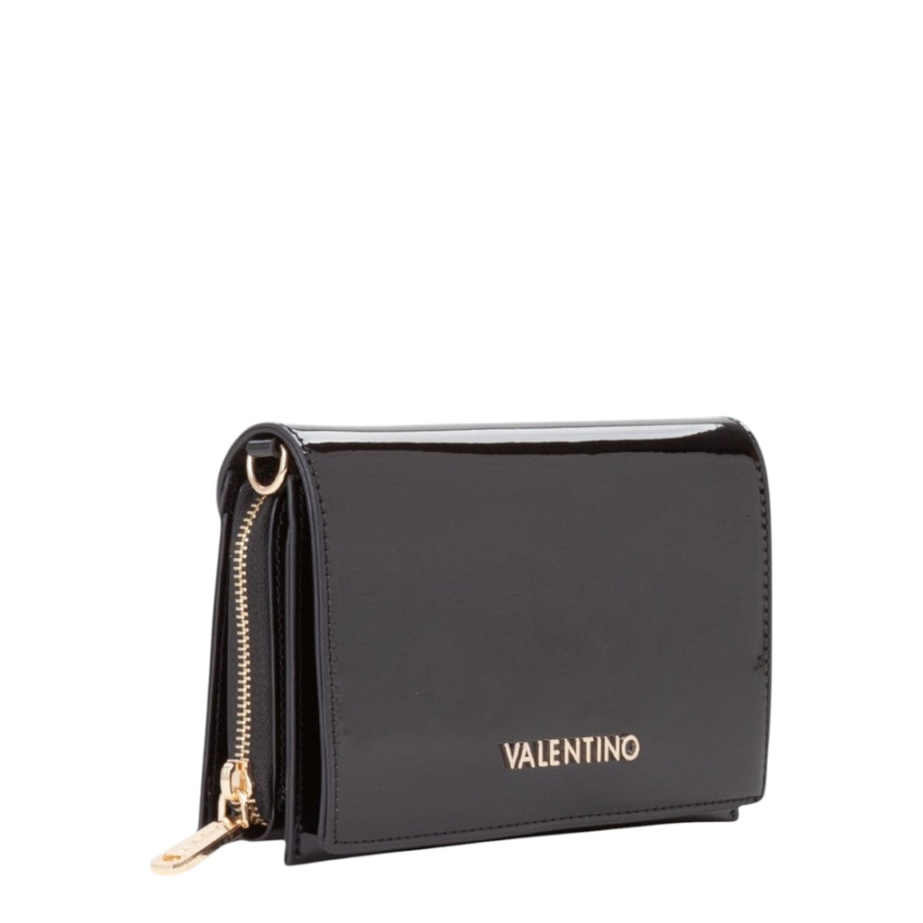 Lieblingstasche Flap Bag Ember, a black patent leather wallet with gold hardware and a zip closure.