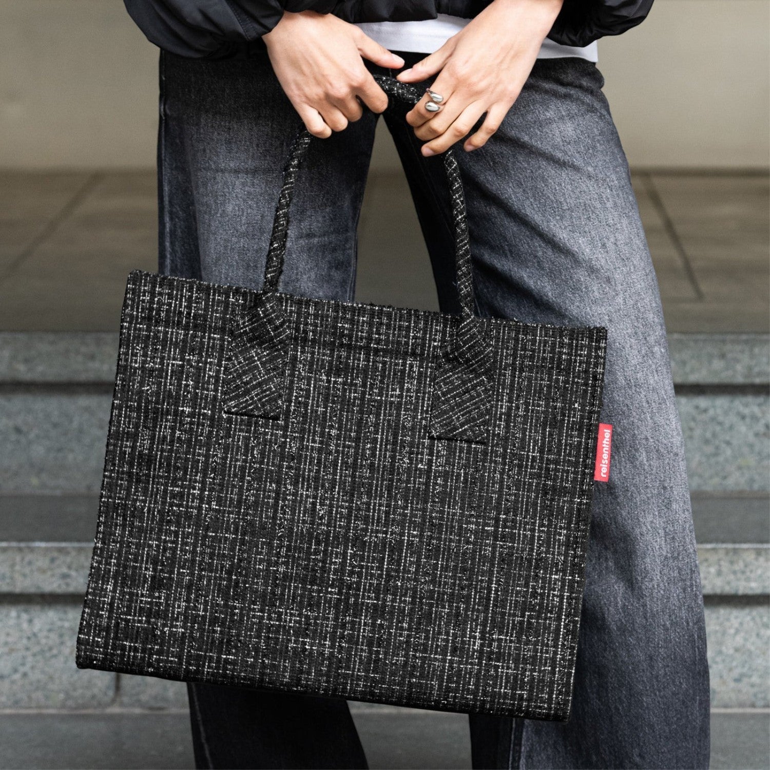 Lieblingstasche black and white textured shopper bag with braided handles and red logo tag.
