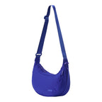 Lieblingstasche blue crescent-shaped sling bag with an adjustable shoulder strap and zippered closure