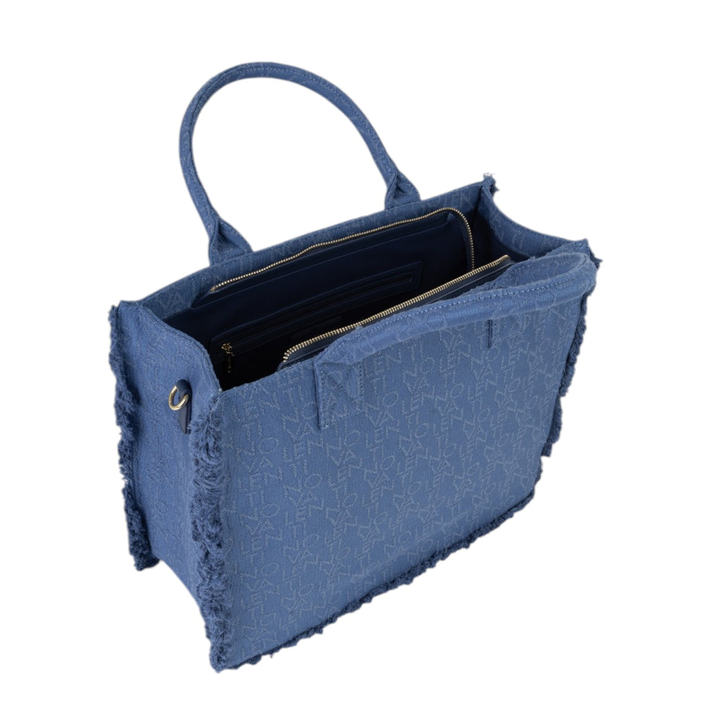 Lieblingstasche blue denim tote bag with frayed edges and all-over logo pattern. Open top with zippered compartments.
