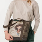 Lieblingstasche shoulder bag featuring a whimsical girl illustration and brown textured panels held by a model