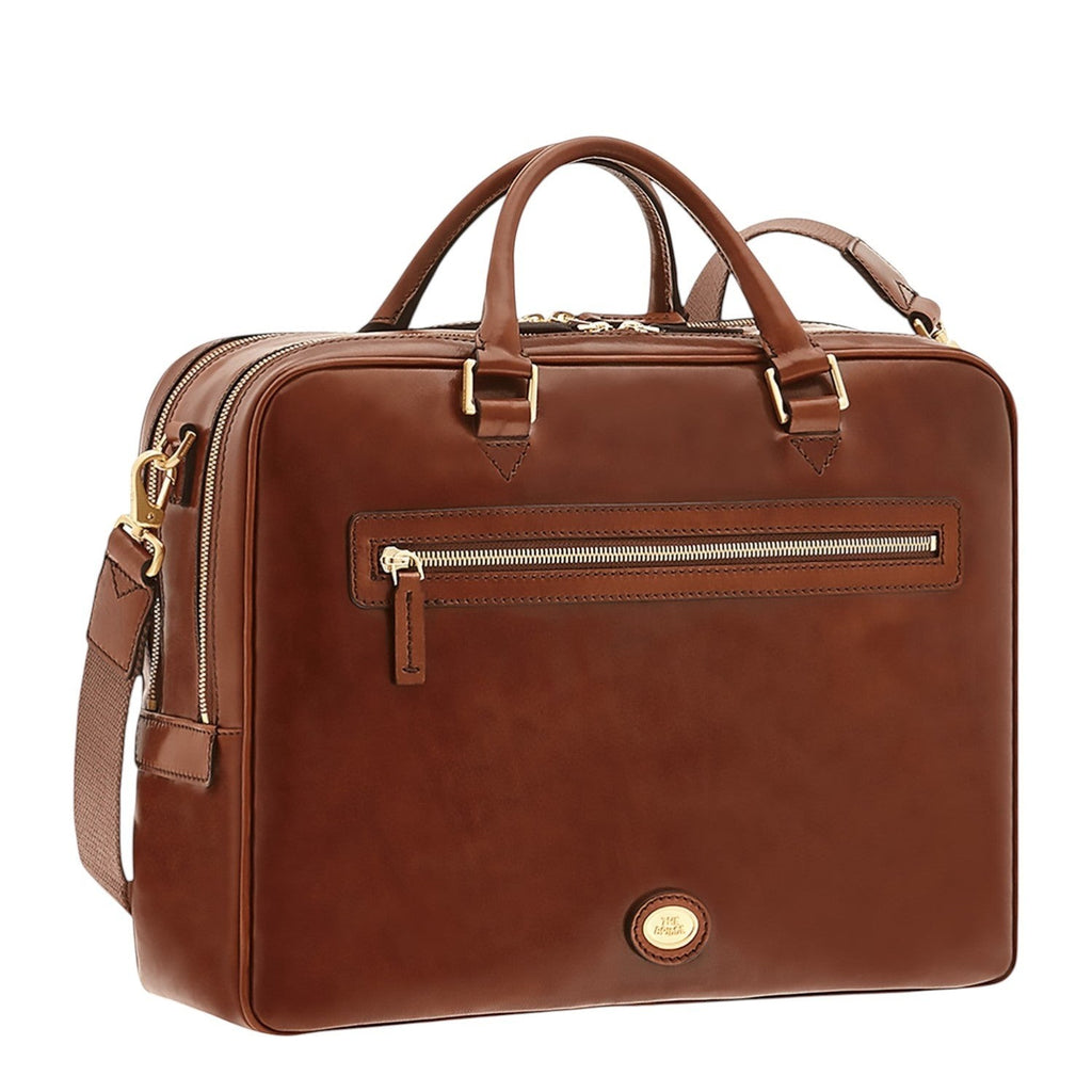 Lieblingstasche brown leather briefcase with top handles, adjustable shoulder strap, and multiple zippered compartments.