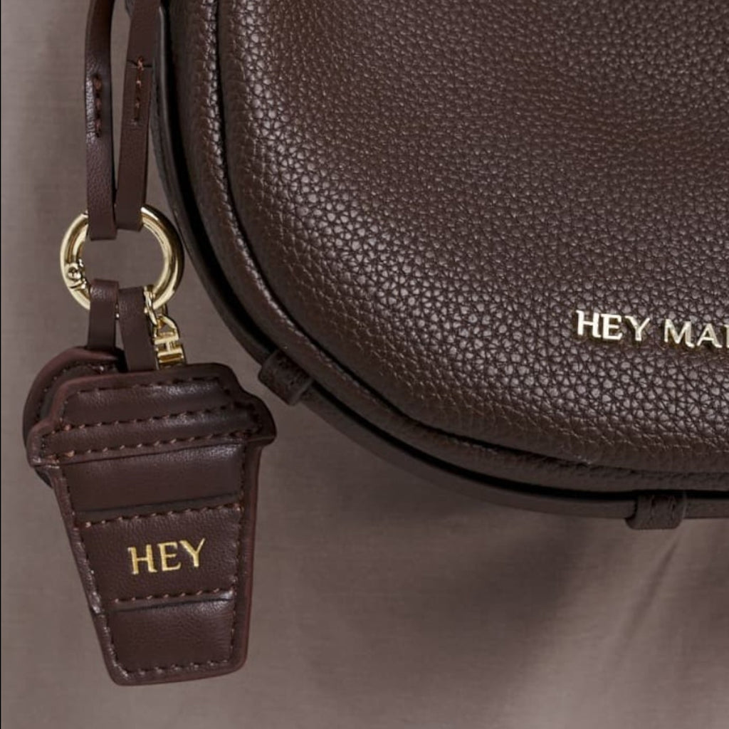 Lieblingstasche Coffee Charm dark brown pebbled leather crescent crossbody bag with gold hardware and logo charm