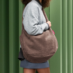 Lieblingstasche brown teddy fleece moonbag worn over the shoulder by a woman in a grey sweater