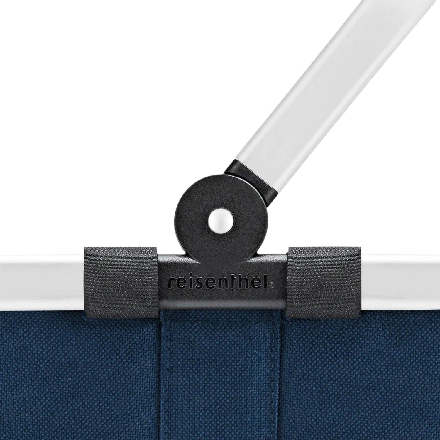Close-up of the Lieblingstasche Carrybag XS showing the blue fabric, white handle, and black hinge mechanism.