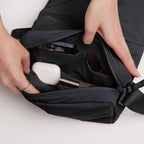 Lieblingstasche Cloud Crossbody Bag in black with open main compartment showing organized pockets and personal items