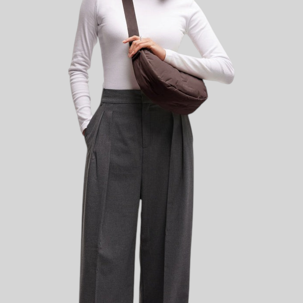 Lieblingstasche Cloud Moon Bag Small in dark brown worn as a crossbody bag by a smiling woman in casual attire.