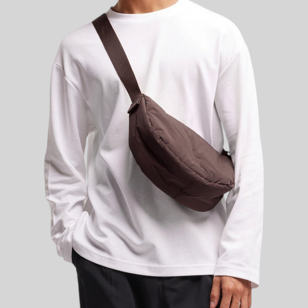 Lieblingstasche Cloud Moon Bag Small in dark brown worn as a crossbody bag by a man in a white long-sleeve shirt