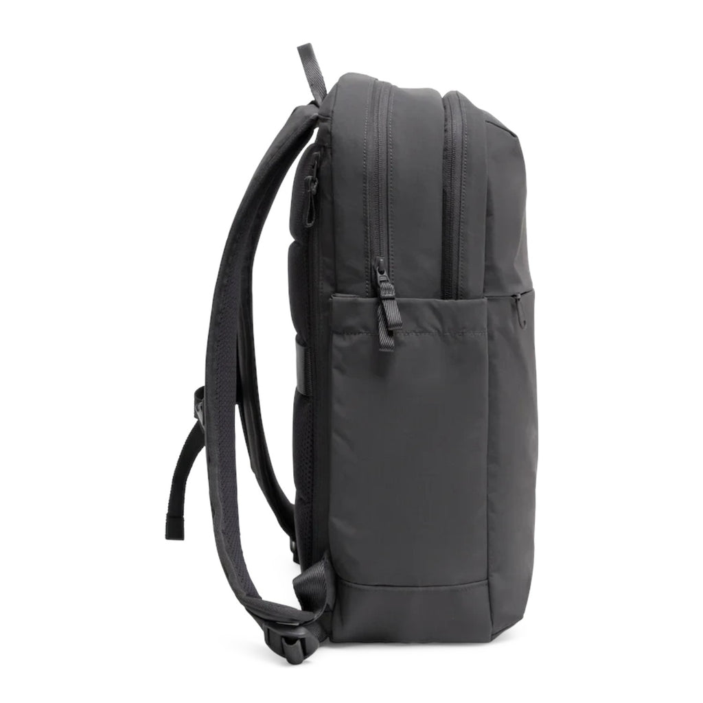 Lieblingstasche Commuter Pack in black, side view of a minimalist water-resistant laptop backpack with zip pockets.