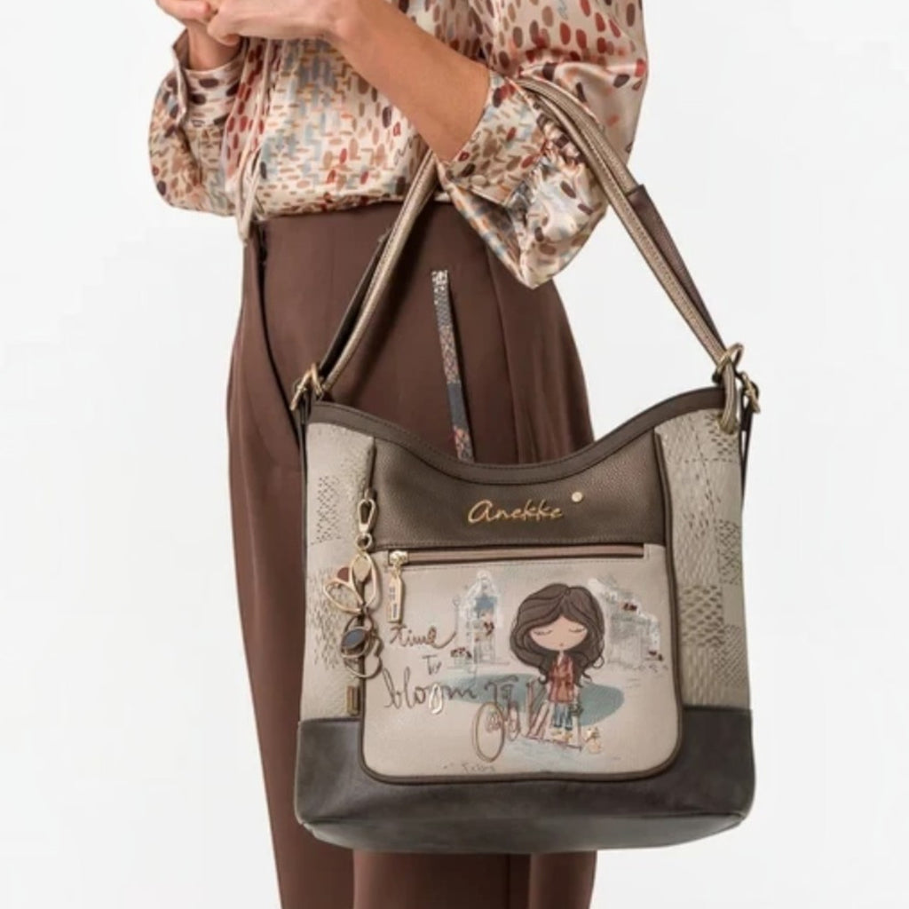 Lieblingstasche convertible backpack featuring Anekke illustration, brown and beige tones, and gold-tone hardware.