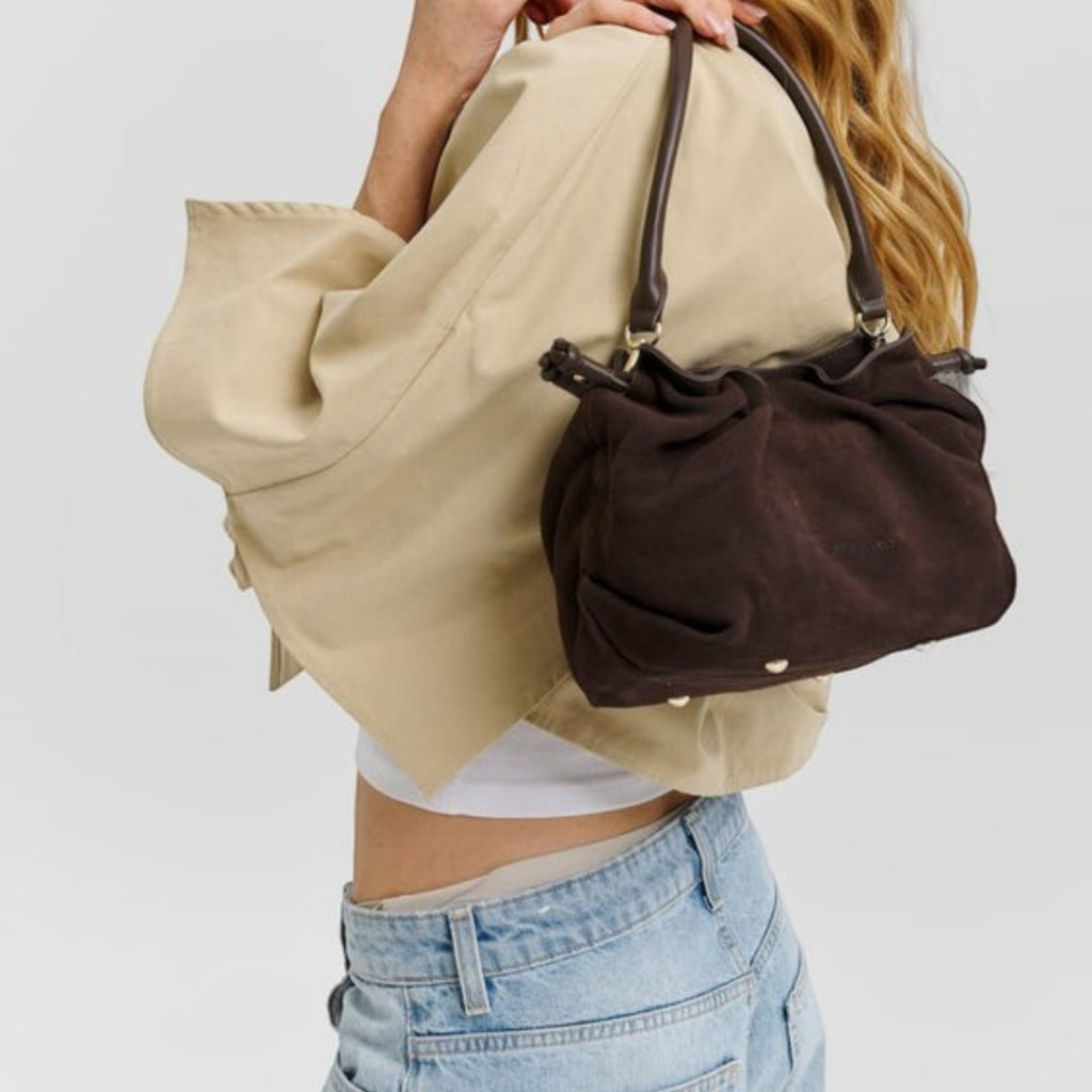Lieblingstasche Cool Companion Suede S dark brown suede handbag with gathered detail carried by a blonde model