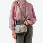 Lieblingstasche cross-body bag featuring a whimsical Aneke illustration on a grey and black structured design