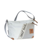 Lieblingstasche Deern Lütt crossbody bag made from recycled white and grey sailcloth with brown leather accents.