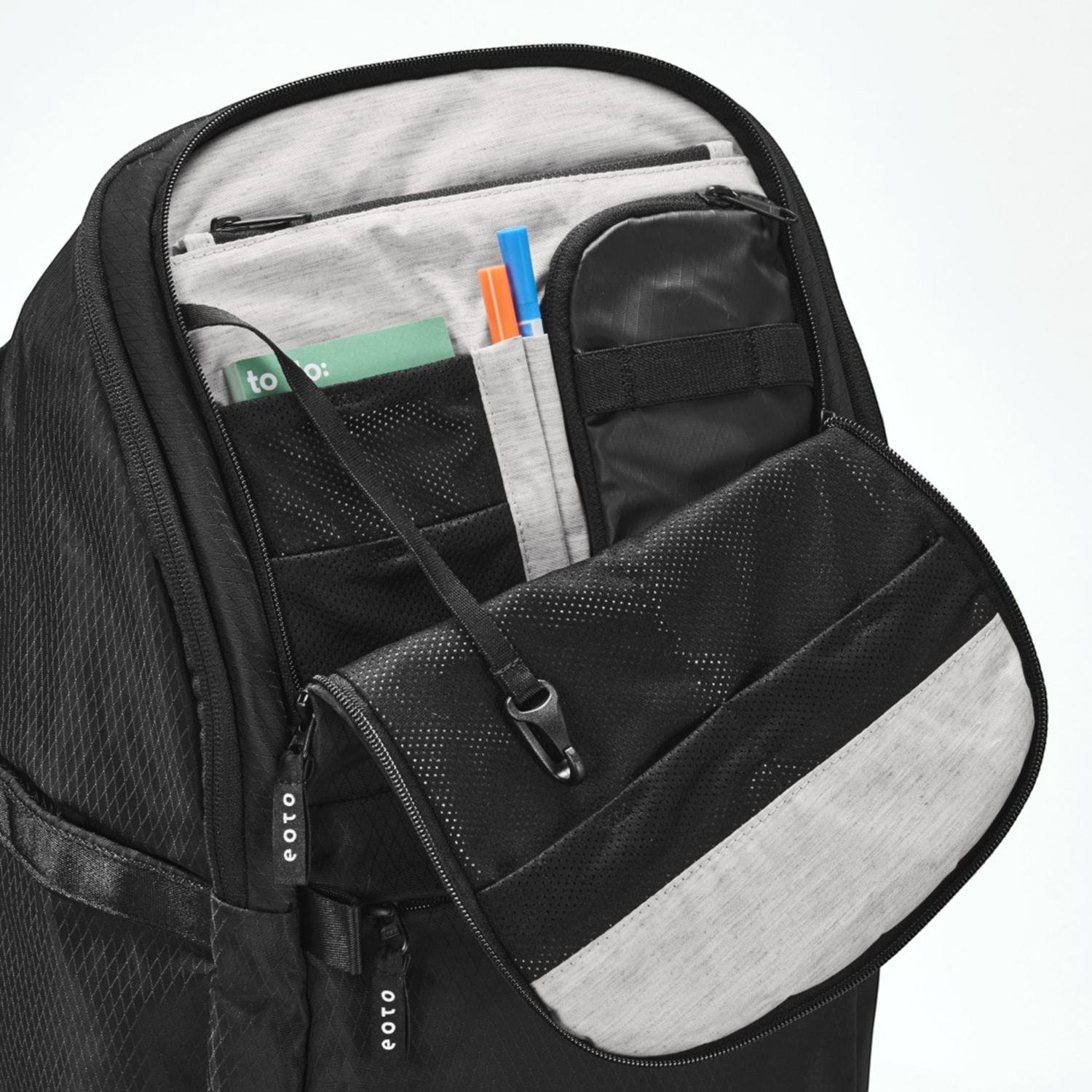 Lieblingstasche eoto Easy27 black backpack showing the open front organizer compartment with mesh pockets and pen slots