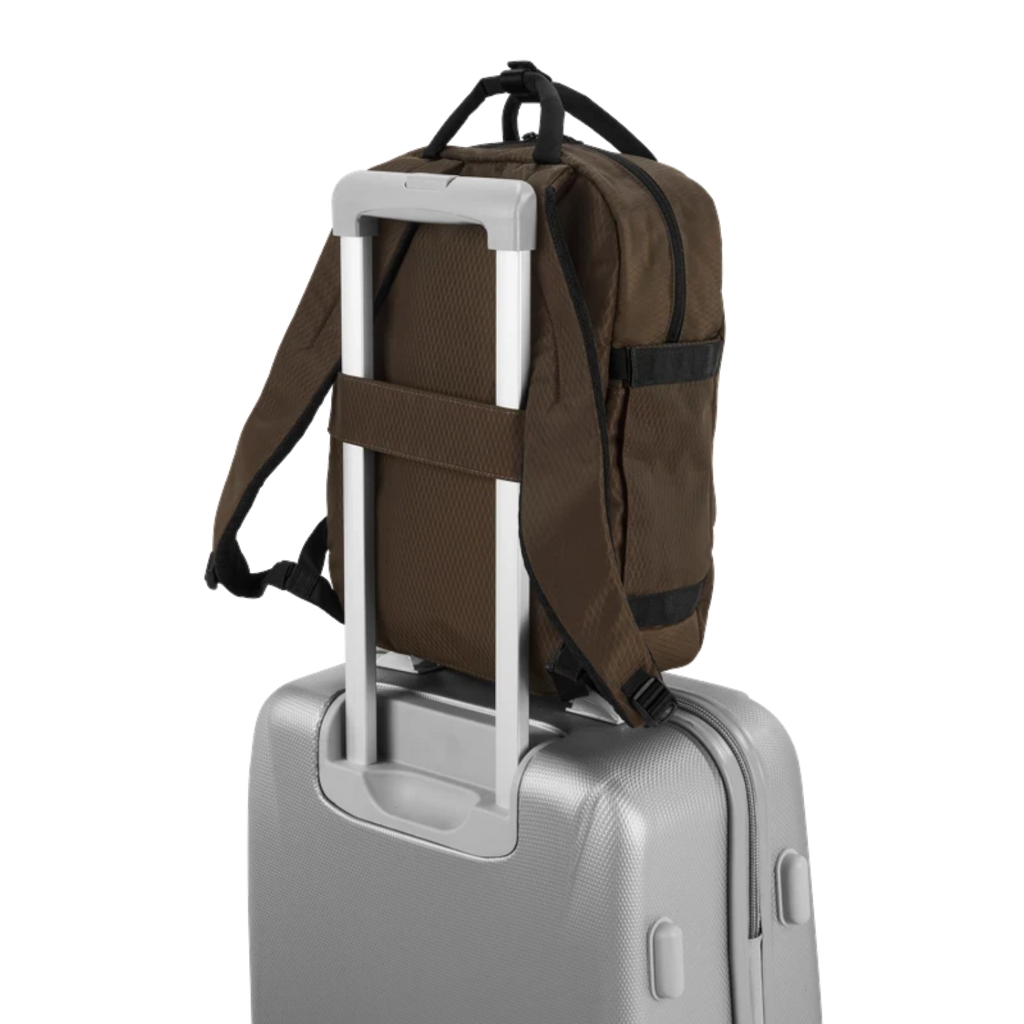Lieblingstasche eoto Small16 brown compact daypack attached to a silver trolley suitcase handle