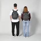 Lieblingstasche eoto Small16 grey compact daypack worn by a man and a woman in a studio setting