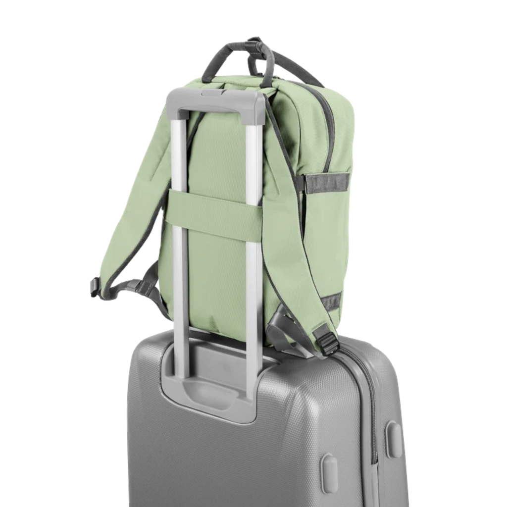 Lieblingstasche eoto Small16 sage green compact daypack attached to a grey rolling suitcase handle