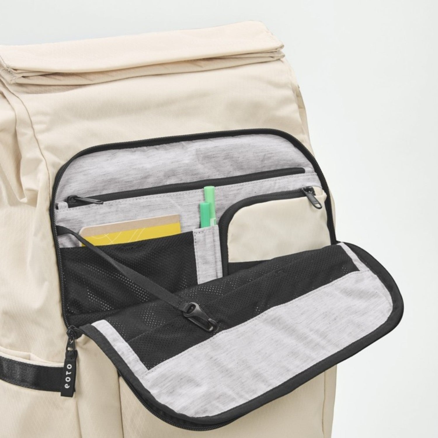 Lieblingstasche eoto Tall41 beige rolltop backpack showing open front organizer pocket with mesh and pen slots