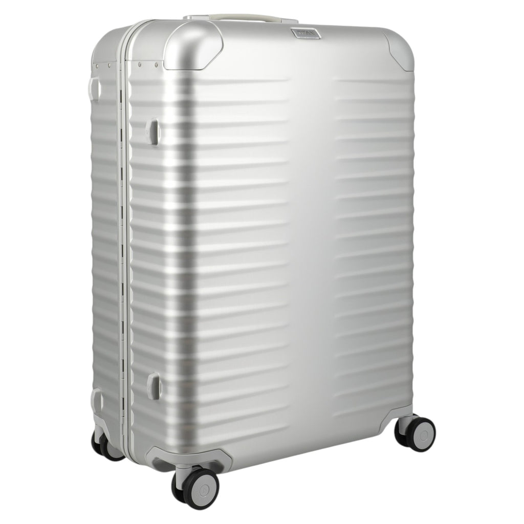 Lieblingstasche Eternity L silver aluminium suitcase with ribbed texture, leather handles, and spinner wheels.