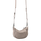 Lieblingstasche Fawn taupe leather crossbody bag with a curved silhouette, adjustable strap, and side zipper detail.