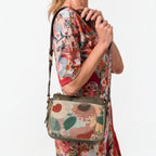 Lieblingstasche cross-body bag with floral embroidery and olive green trim worn by a woman in a matching dress