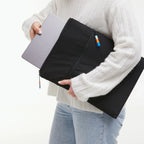 Lieblingstasche GOT BAG black laptop sleeve with a silver laptop being inserted by a person in a white sweater