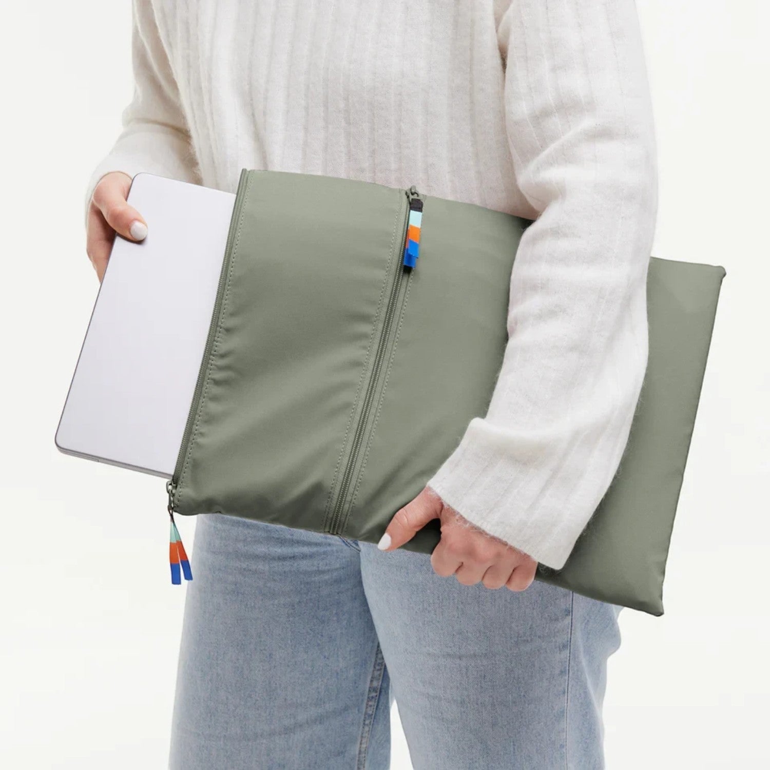 Lieblingstasche GOT BAG olive green laptop sleeve with zipper and colorful pull tabs held by a person