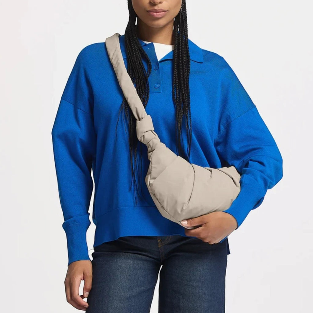 Lieblingstasche GOT BAG Pleat Moon Bag Small in beige, worn as a crossbody bag by a model in a blue sweater.