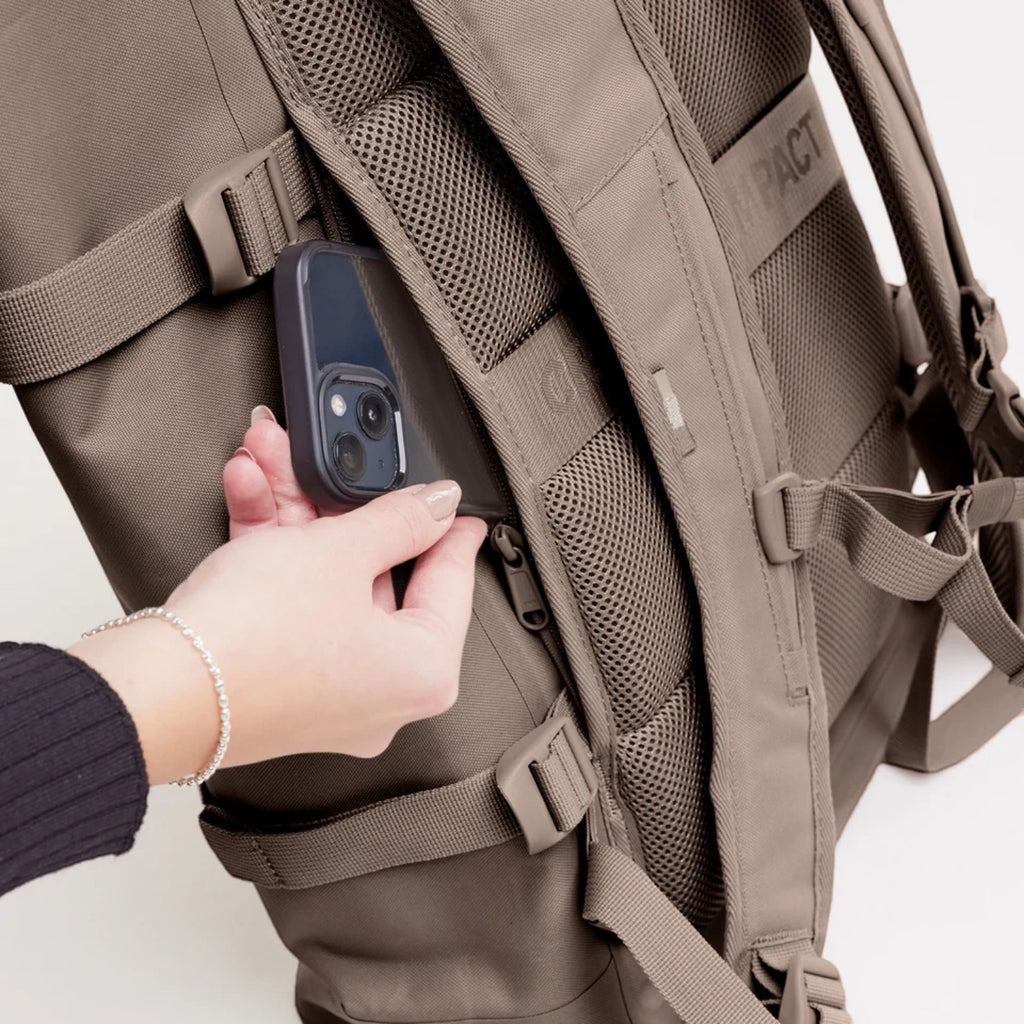 Lieblingstasche GOT BAG Rolltop 2.0 backpack in taupe showing the secure zippered back pocket with a smartphone