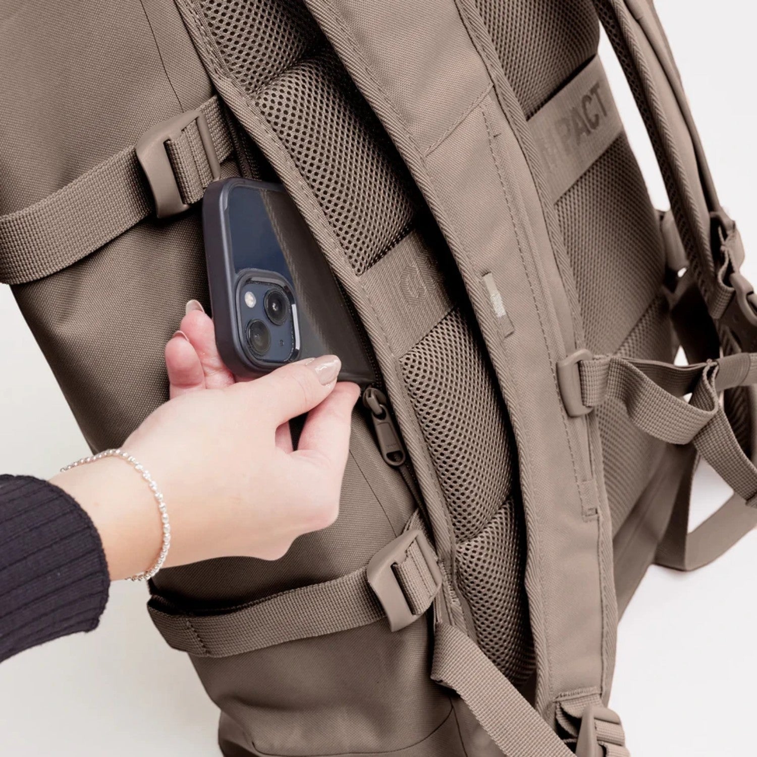 Lieblingstasche GOT BAG Rolltop 2.0 backpack in taupe showing the secure zippered back pocket with a smartphone