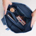 Lieblingstasche GOT BAG Rolltop 2.0 backpack interior showing laptop sleeve, water bottle, and books in blue fabric.