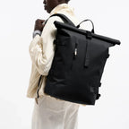 Lieblingstasche GOT BAG Rolltop 2.0 backpack in black worn by a model against a white background
