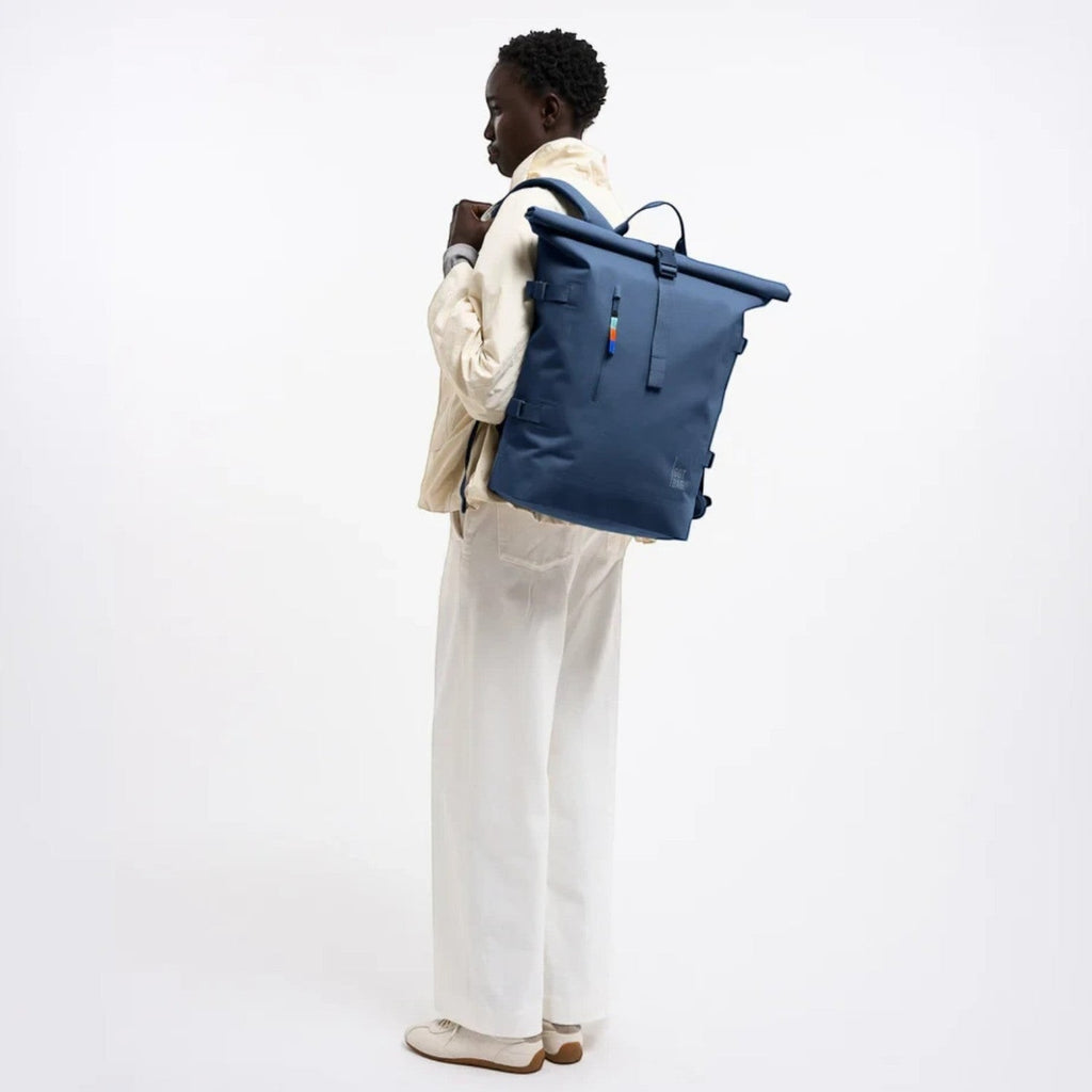 Lieblingstasche GOT BAG Rolltop 2.0 backpack in blue worn by a model against a white background