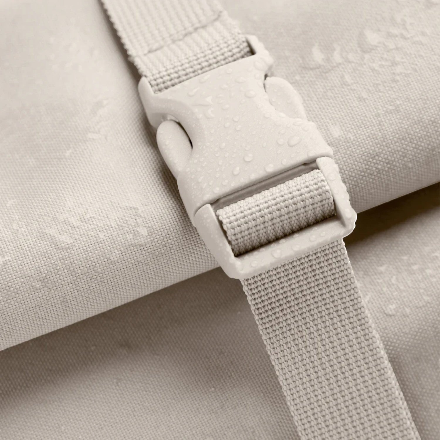 Lieblingstasche GOT BAG Rolltop 2.0 backpack detail showing beige water-repellent fabric and a sturdy plastic buckle