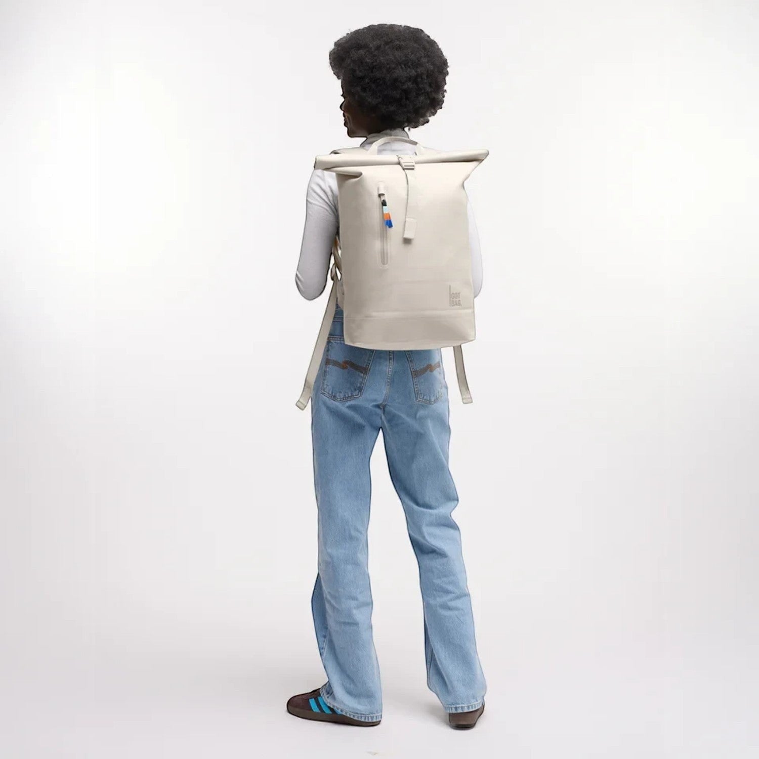 Lieblingstasche GOT BAG Rolltop Lite 2.0 backpack in beige worn by a model against a white background