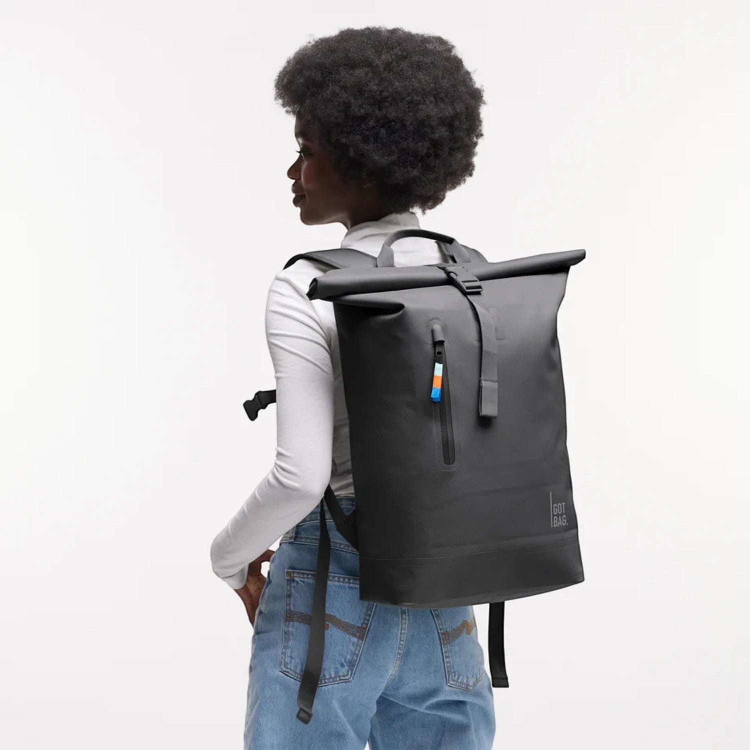 Lieblingstasche GOT BAG Rolltop Lite 2.0 black backpack with magnetic closure worn by a model against white background